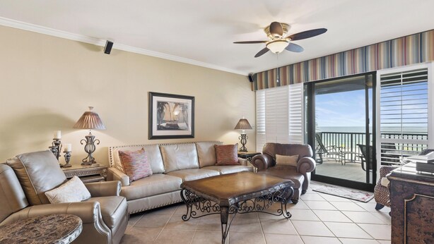 A living room with a sofa, armchairs, a coffee table, and a ceiling fan. - Romar House 304A by Liquid Life (Orange Beach)