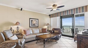A living room with a sofa, armchairs, a coffee table, and a ceiling fan. - Romar House 304A by Liquid Life (Orange Beach)