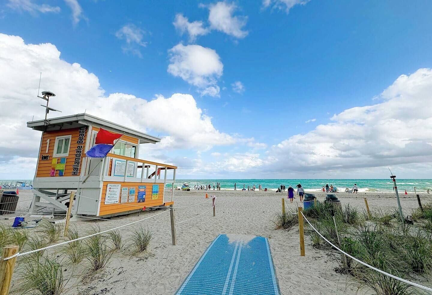 A lifeguard tower with a beach in the background.