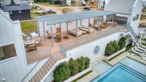 A modern residential complex with a rooftop deck, outdoor seating area, and a swimming pool. - North Gable- Bunkhouse in Steele Park with Private Pool and Hot Tub access (Carlton Landing)