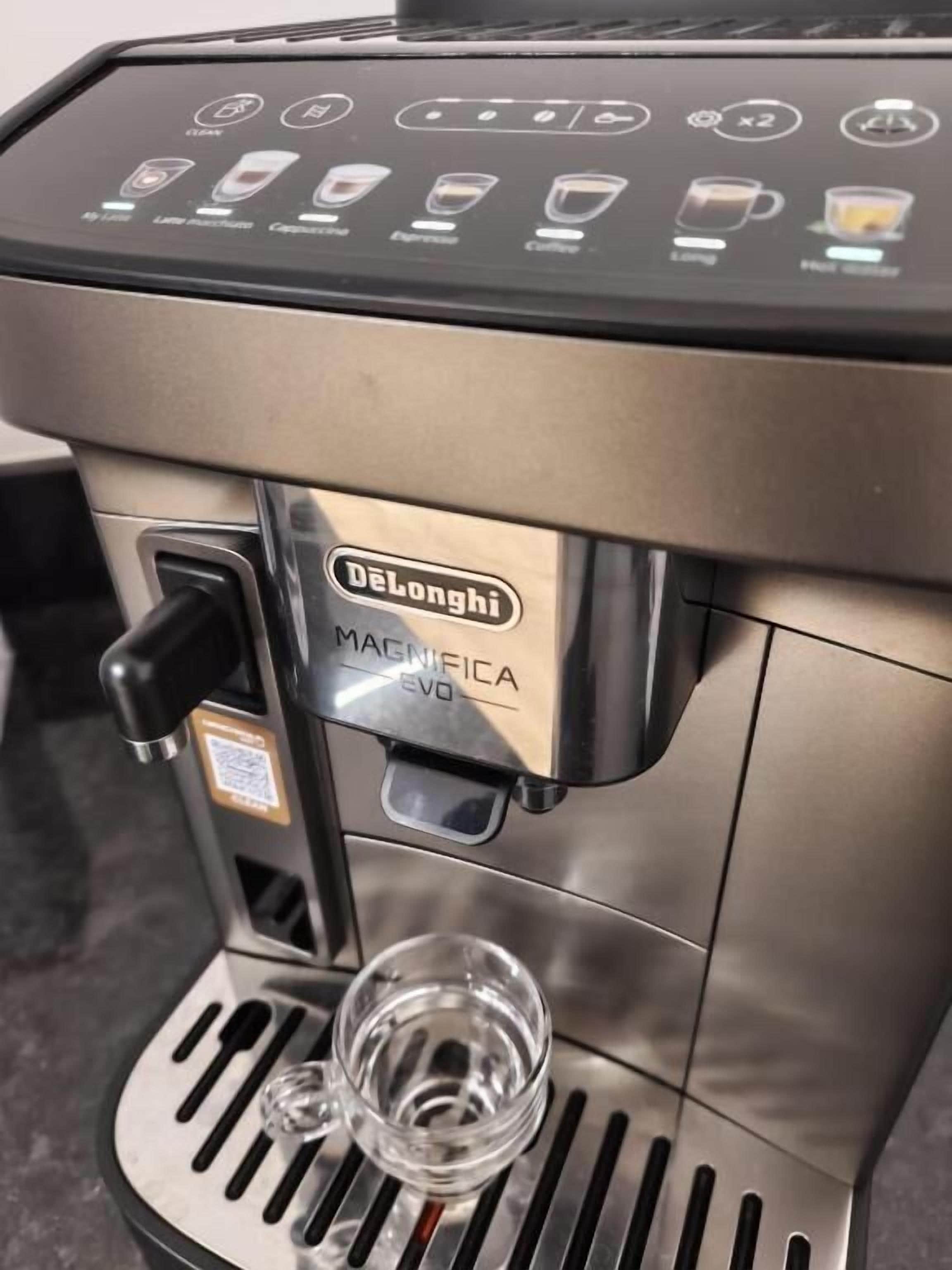 A DeLonghi MAGNIFICA EVO coffee machine with a control panel and a water reservoir.