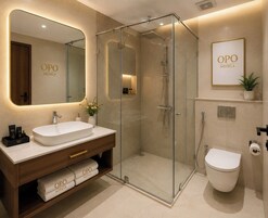 A modern bathroom with a glass-enclosed shower, a large mirror, and a sink with a vanity.