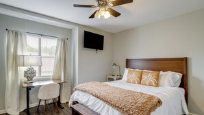 A bedroom with a bed, a desk, a chair, a ceiling fan, a TV, and a window with curtains. - Walk to Park w/ Pond, Trails & More! Sherwood Unit (Sherwood)