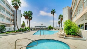 A swimming pool with a 2 ft ladder, surrounded by palm trees and a covered seating area. - Poolside Fun, Ocean Strolls! Corpus Christi Escape (Corpus Christi)