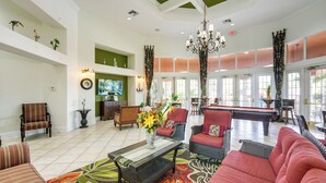 A spacious lobby with a pool table, comfortable seating, and a large window allowing natural light. - Near Disney & Universal: Home w/ Pool & Spa! (Davenport)