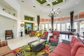 A spacious lobby with a pool table, comfortable seating, and a large window allowing natural light. - Near Disney & Universal: Home w/ Pool & Spa! (Davenport)