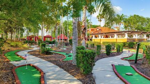 A miniature golf course with a red-roofed building in the background. - Near Disney & Universal: Home w/ Pool & Spa! (Davenport)