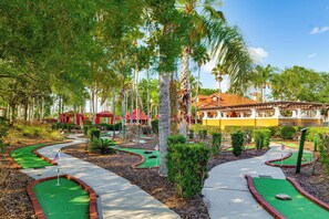 A miniature golf course with a red-roofed building in the background. - Near Disney & Universal: Home w/ Pool & Spa! (Davenport)