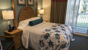 A hotel room with a bed, a desk, a chair, a nightstand with a lamp, and a window with curtains. - The Best Unit at the Best Resort during the Best Week on Cape Code (Yarmouth)