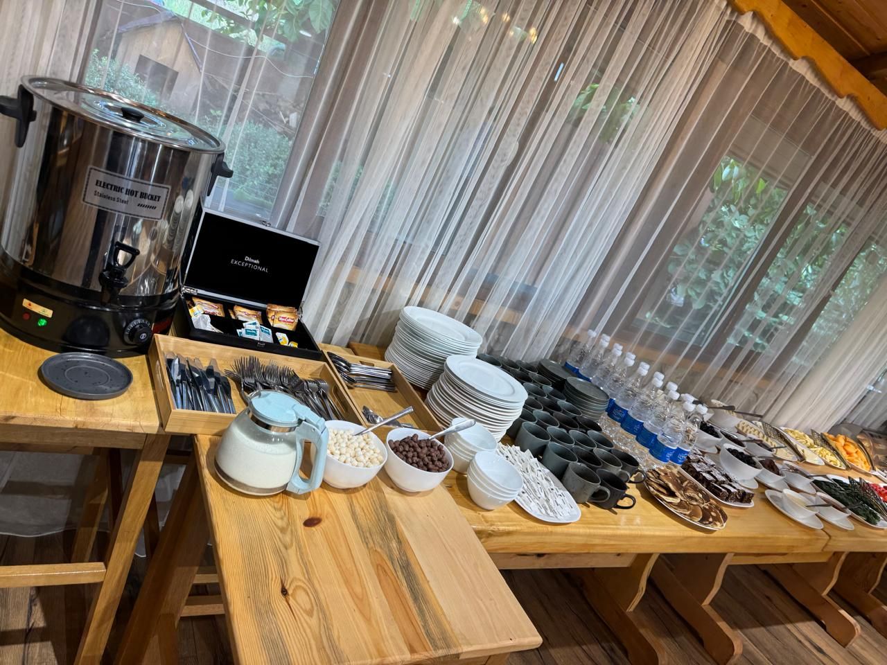 A buffet setup with various food items and utensils.