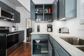 Eine moderne Küche mit Einbauofen, Kaffeemaschine und Toaster.