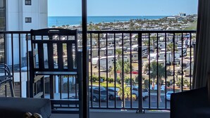 A balcony with a view of a parking lot and a beach. - 1BR Ocean View Condo | Myrtle Beach Resort B0530 (Myrtle Beach)