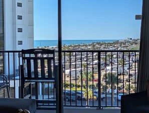 A balcony with a view of the ocean and a parking lot. - 1BR Ocean View Condo | Myrtle Beach Resort B0530 (Myrtle Beach)