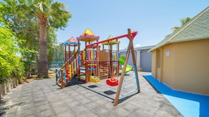 A playground with a climbing structure, swings, and a slide. - Hotel Esra Family Suite - All inclusive (Didim)