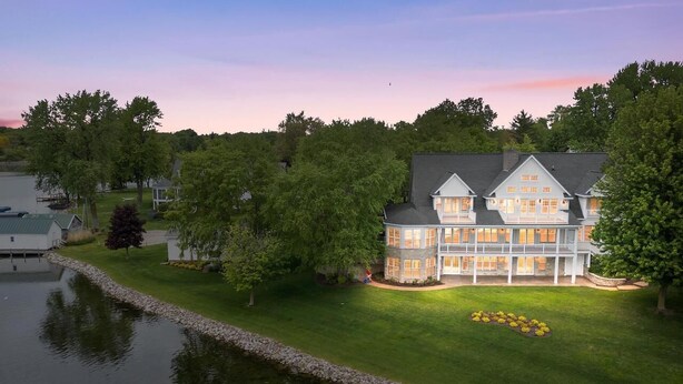 A large, multi-story house with a dock and a pond. - Expansive Luxury at The Waterfront on Green Lake (Green Lake)
