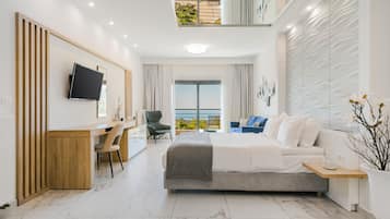 A modern hotel room with a bed, desk, chair, and a balcony with a view.