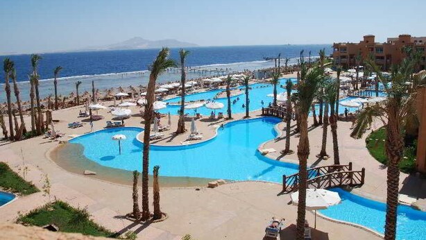 A resort with multiple swimming pools, palm trees, and a beach view. - Rehana Royal Beach Resort (Sharm El Sheikh)