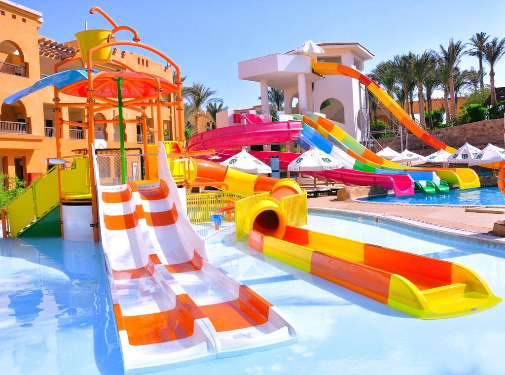 A water park with multiple slides and a pool.