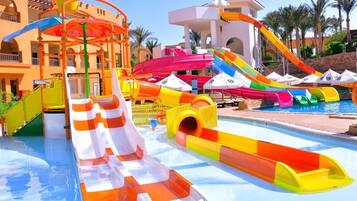 A water park with multiple slides and a pool.