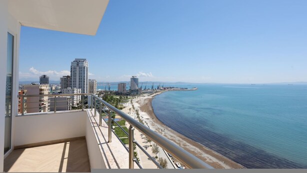 A balcony with a view of a beach and cityscape. - Grandstay Sea Penthouse 02 (Durrës)