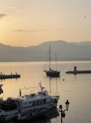 A calm harbor with boats, a pier, and distant mountains. - Calvi plage T3 (Calvi)