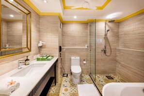 A bathroom with a shower, toilet, sink, and a mirror. - Mayfair Lagoon Bhubaneswar (Bhubaneshwar)