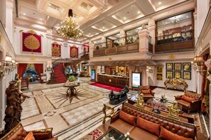 A grand lobby with a chandelier, a reception desk, and a staircase. - Mayfair Lagoon Bhubaneswar (Bhubaneshwar)