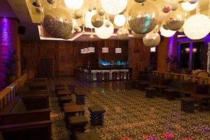 A bar area with wooden paneling, hanging disco balls, and patterned flooring. - Sandos Caracol Eco Resort - Select Club - All Incl (Playa del Carmen)