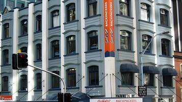 A multi-story building with a prominent sign for 'Backpackers.'