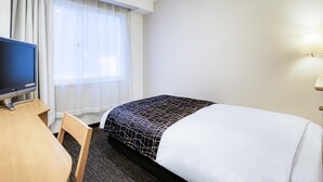 A hotel room with a bed, a desk, a television, and a window with curtains. - APA Hotel Marugame-ekimae-odori (Marugame)