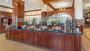 A buffet area with a marble counter, glass railings, and a variety of food service equipment. - Drury Inn Union Station (St. Louis)