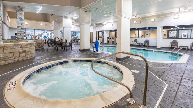 A hotel lobby with a hot tub, a pool, and a seating area with tables and chairs. - Drury Inn Union Station (St. Louis)