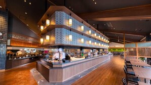 A modern restaurant with a central counter, multiple seating areas, and a patterned wall design. - Taoya Nachikatsuura (Nachikatsuura)