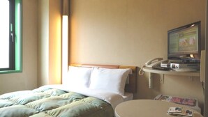 A hotel room with a bed, a round table with a magazine, a TV, and a telephone. - R&B Hotel Sendai-hirosedoriekimae (Sendai)