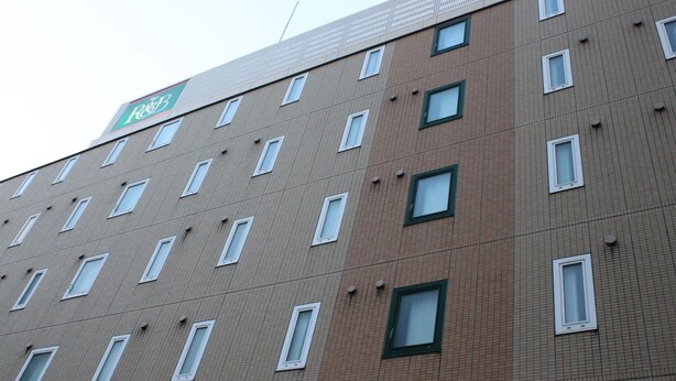 A multi-story building with a grid of windows and a green sign on the top. - R&B Hotel Sendai-hirosedoriekimae (Sendai)