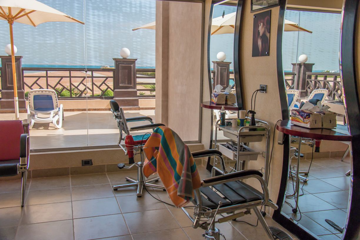 Ein Zimmer mit Meerblick, ein Sessel, ein Tisch mit Stuhl und ein Fenster.