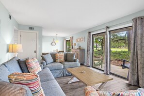 A living room with a sofa, a coffee table, and a view of the outdoors. - ☀️Ground Floor | Golf Cart | Walk to Beach | Seascape 10E⛱️ (Miramar Beach)