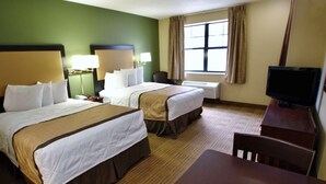 A hotel room with two beds, a desk, a chair, a TV, and a window with curtains. - Extended Stay America - Fort Wayne - South (Fort Wayne)