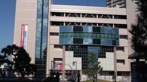 A multi-story building with a modern architectural design, featuring large glass windows and a flat roof. - Reiah Hotel Kusatsu (Kusatsu)