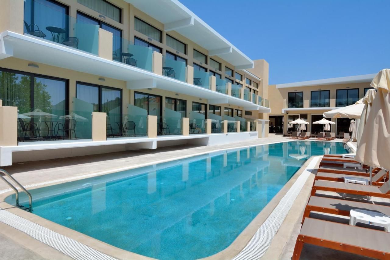 A hotel with a swimming pool, outdoor seating, and a modern architectural design.
