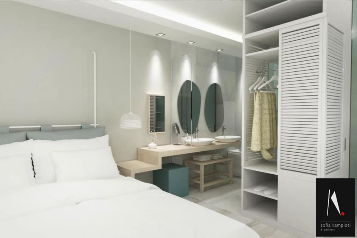 Ein modernes Schlafzimmer mit einem großen Bett, Nachttischen, einem Schreibtisch und einem begehbaren Kleiderschrank.