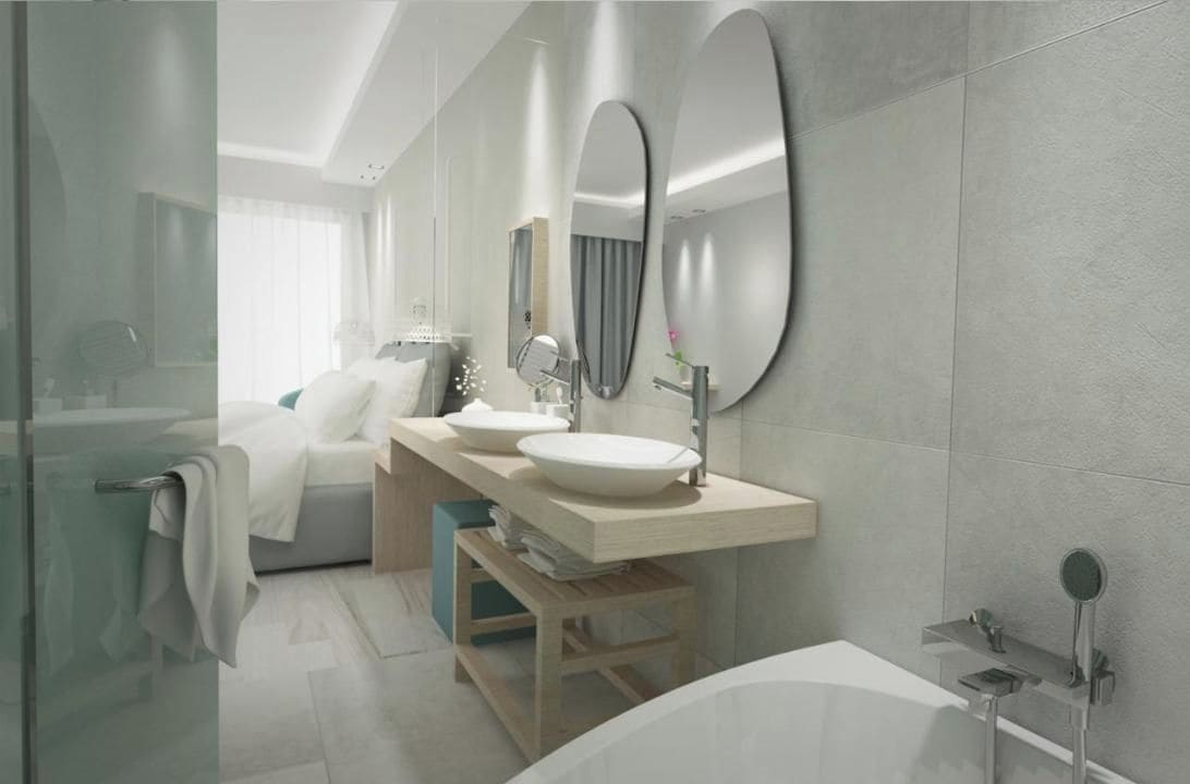 A modern bathroom with a large bathtub, a double sink vanity, and a large mirror.