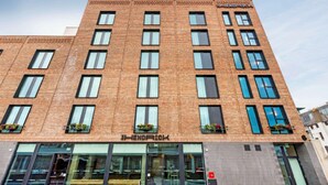 A multi-story brick building with a storefront labeled 'HENDRICK.' - Hendrick Smithfield (Dublin)