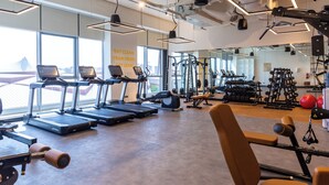 A gym with treadmills, weight machines, and free weights. - Premier Inn Dragon Mart Hotel (Dubai)