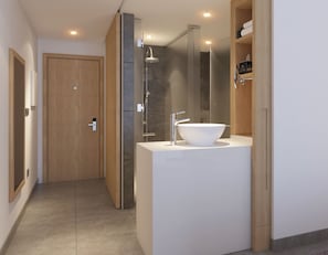 Ein modernes Badezimmer mit einem großen weißen Waschbecken, einer Dusche und einer Holztür.