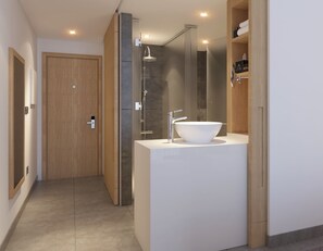 Un baño moderno con un lavamanos grande de color blanco, una ducha y una puerta de madera.