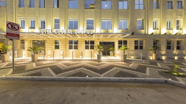 A hotel with a symmetrical facade, multiple windows, and a central entrance. - Hotel Global (São Paulo)