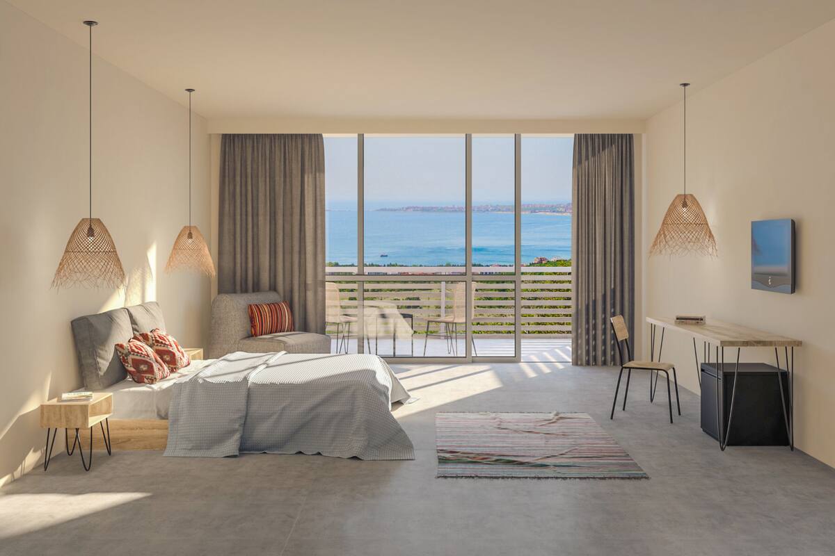 A bedroom with a large window, a bed, a desk, and a chair.