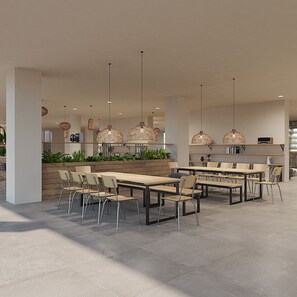 A modern dining area with multiple tables and chairs, hanging wicker chandeliers, and a wooden accent wall. - Cook's Club Sunny Beach (Nessebar)