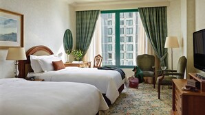 A hotel room with two beds, a television, a desk with a lamp, a chair, and a view of the city through large windows. - The Langham Hotel, Melbourne (Melbourne)